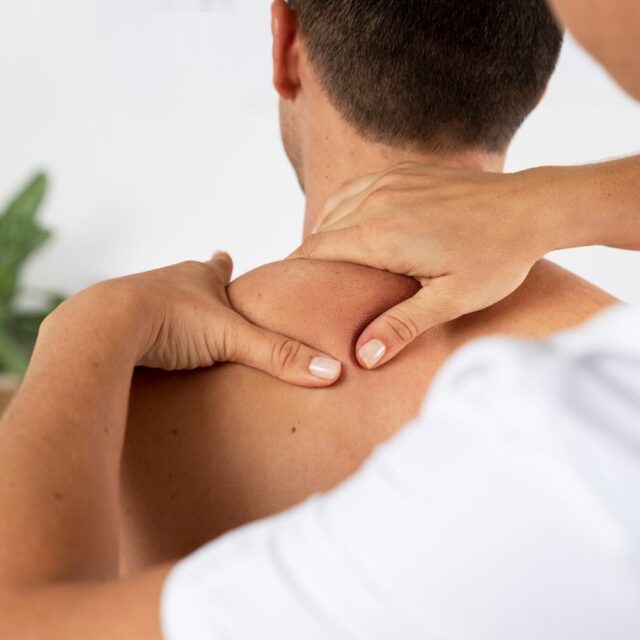 physiotherapist performing therapeutic massage male client